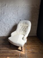 A 19th Century Buttoned Back Bedroom Chair with Turned Legs and Original Castors
